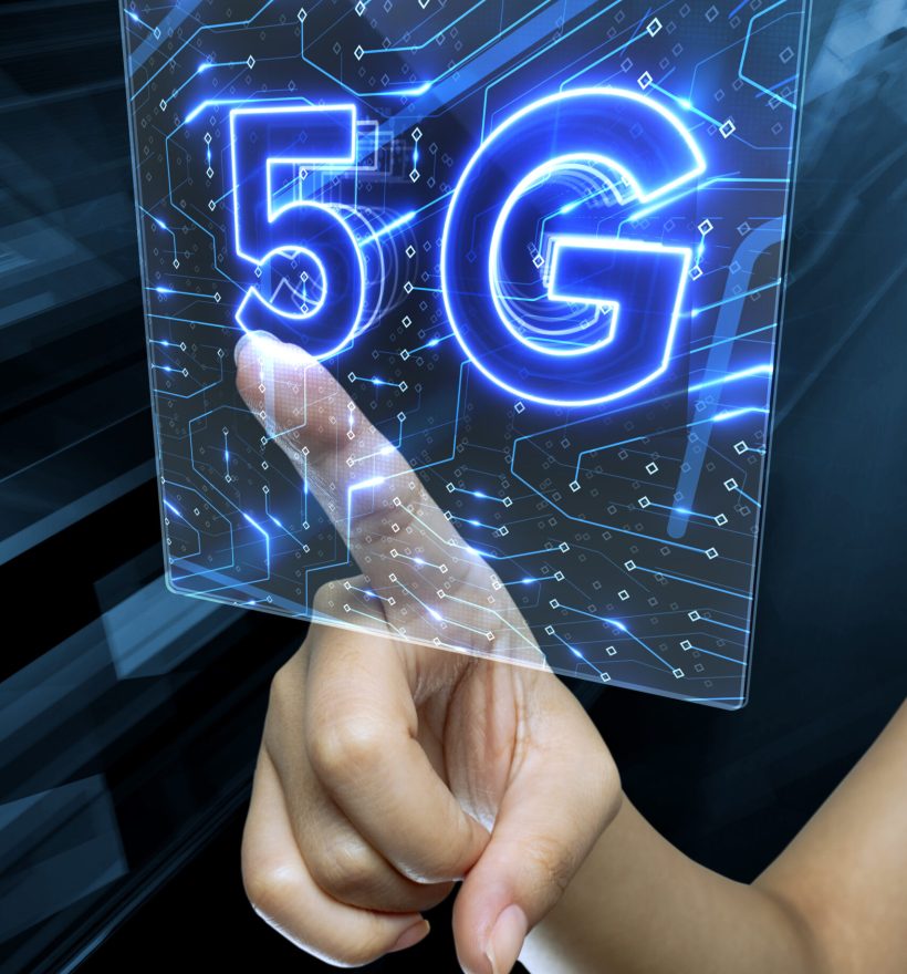 A female's hand touching a digital 3D render screen with 5G sign